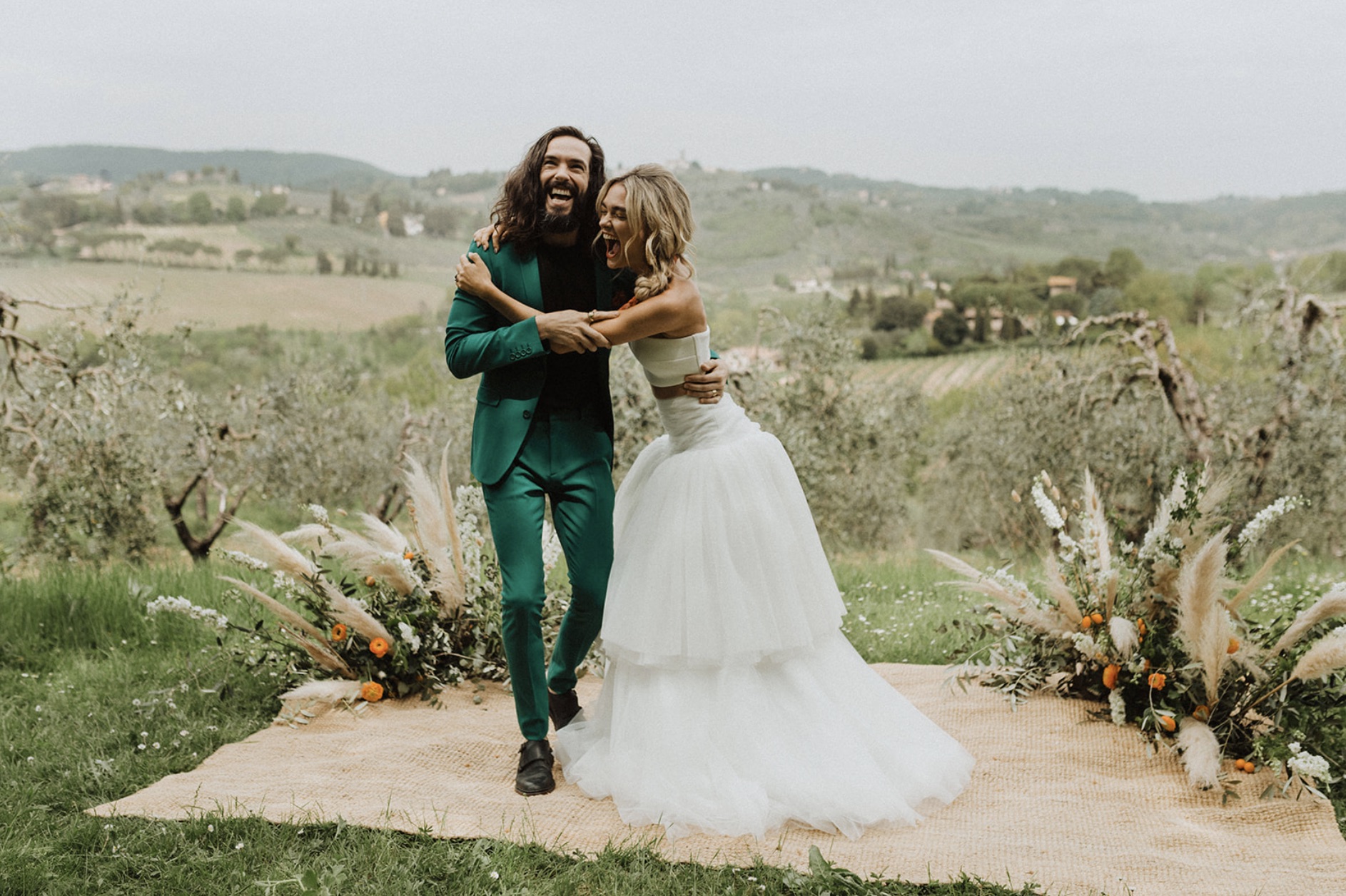 Couple sharing laughs and an embrace as they playfully pose for their Italy elopement shoot