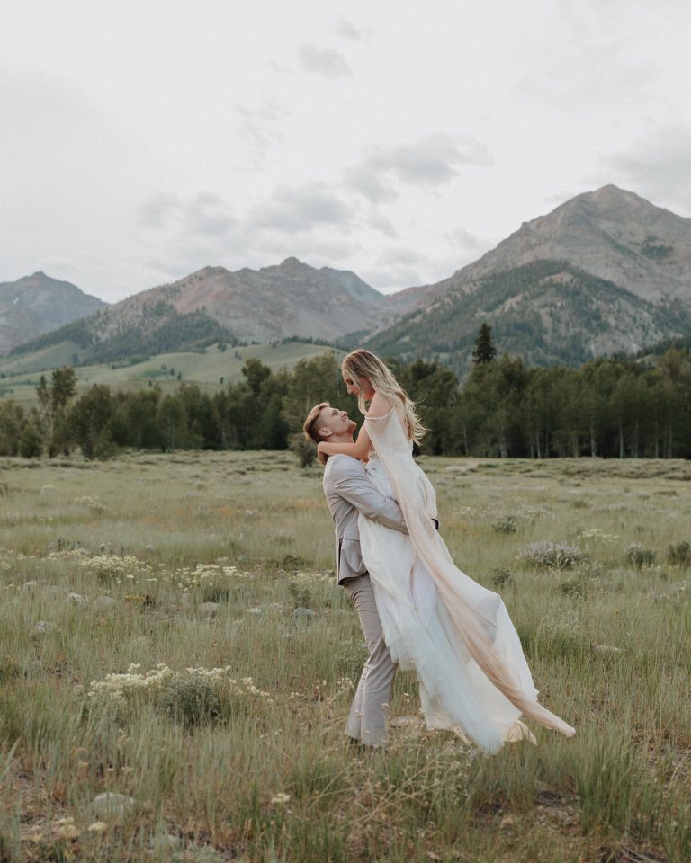 Groom lifts bride up during their elopement in Sun Valley, Idaho taken by Alexa Ann