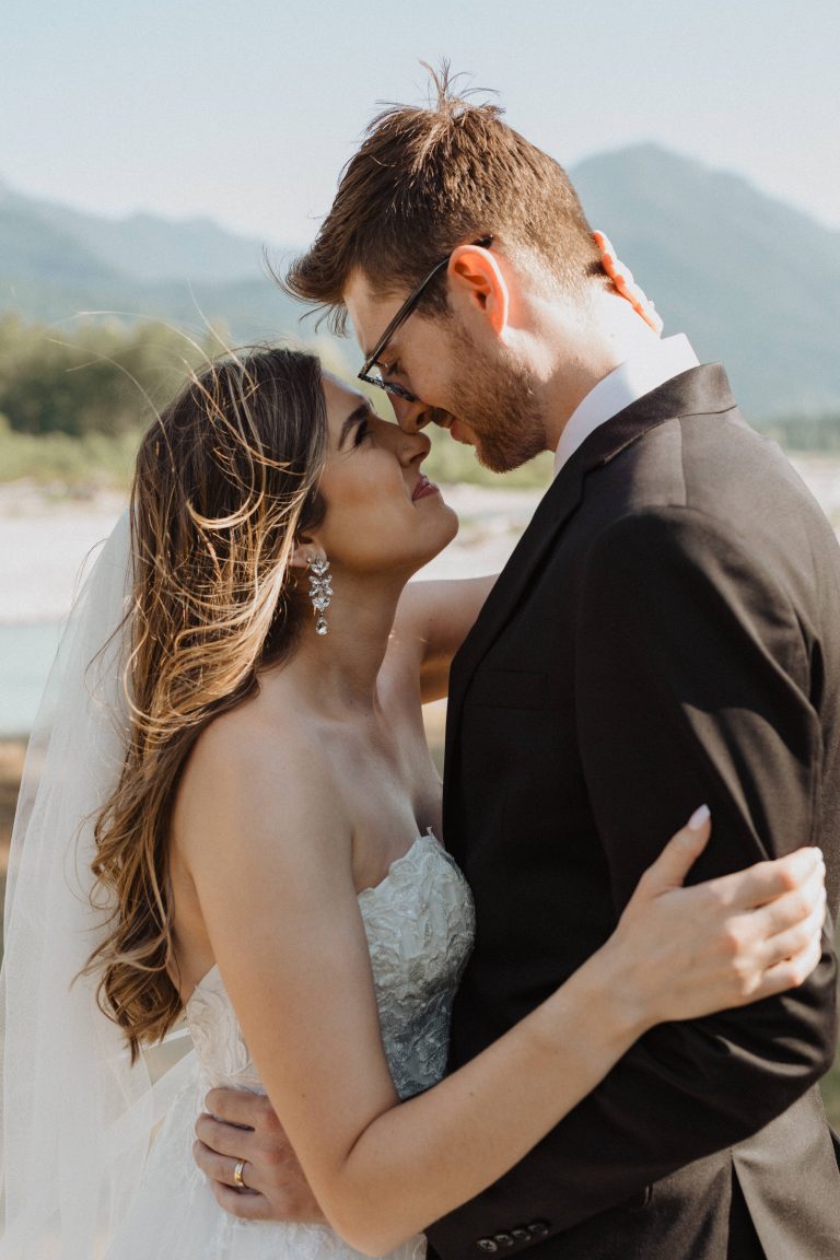 Bride and groom wrap their arms around each other as they look into each other’s eyes, captured by Alexa Ann Photography
