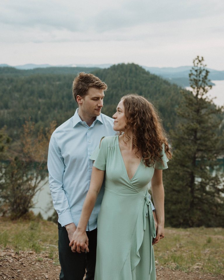 Couple look at each other endearingly during adventurous Coeur d’Alene wedding engagement